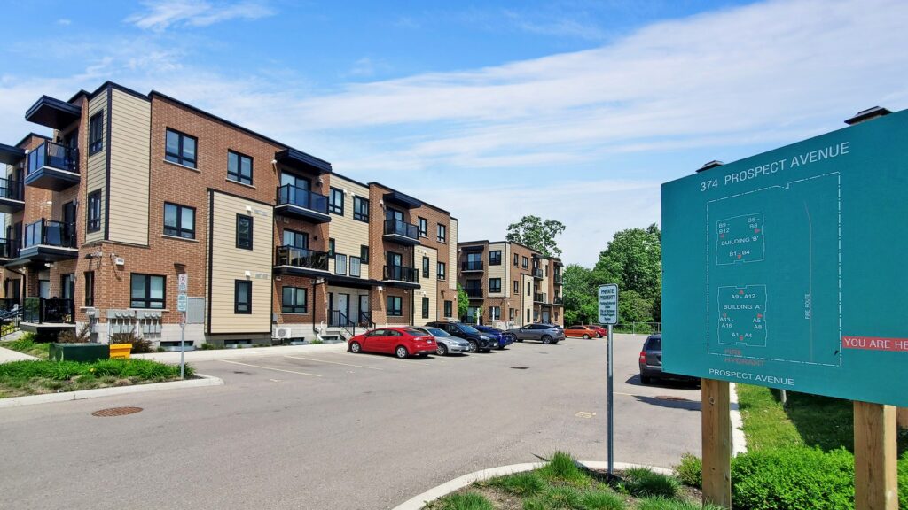 Apartment complex with a parking lot and clear signage for residents and visitors.