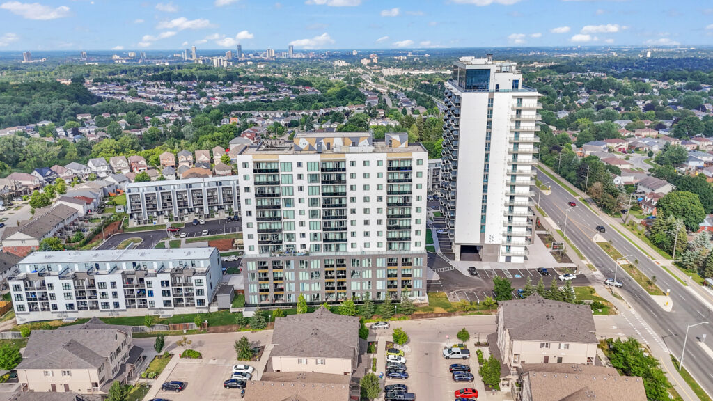 Aerial view of a residential neighborhood filled with houses and numerous parked cars on the streets.