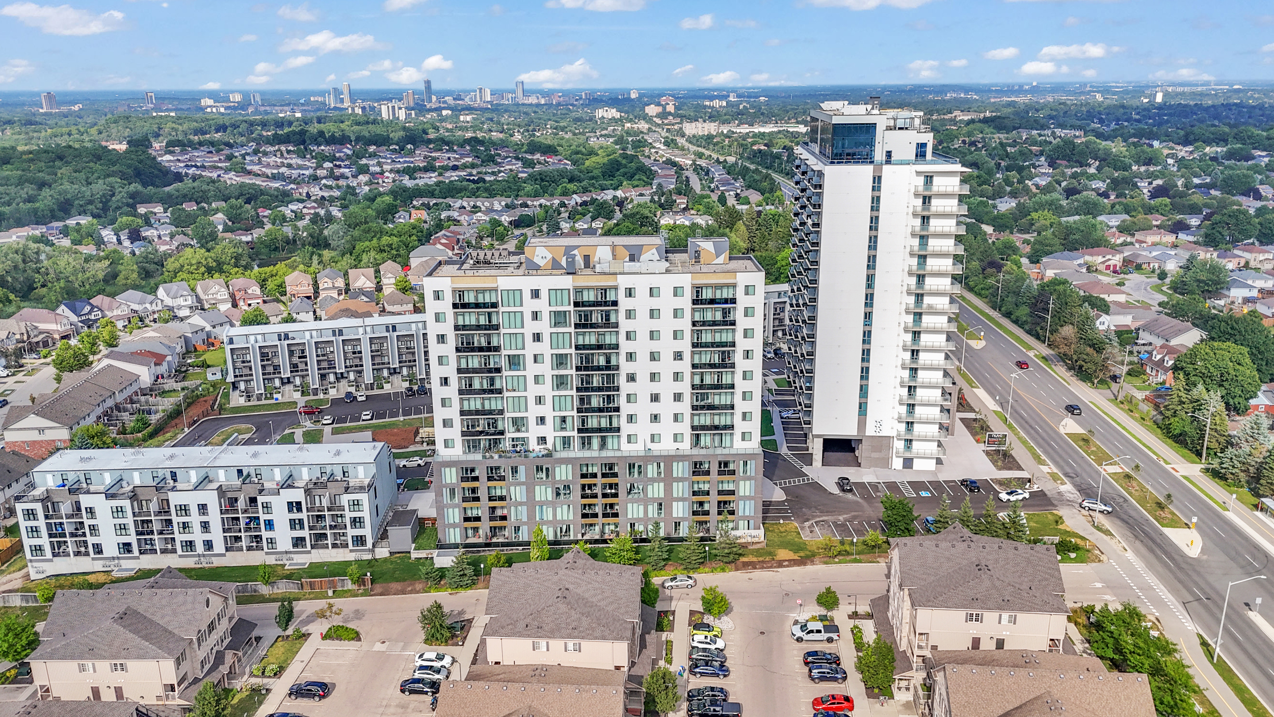 Aerial view of a residential neighborhood filled with houses and numerous parked cars on the streets.