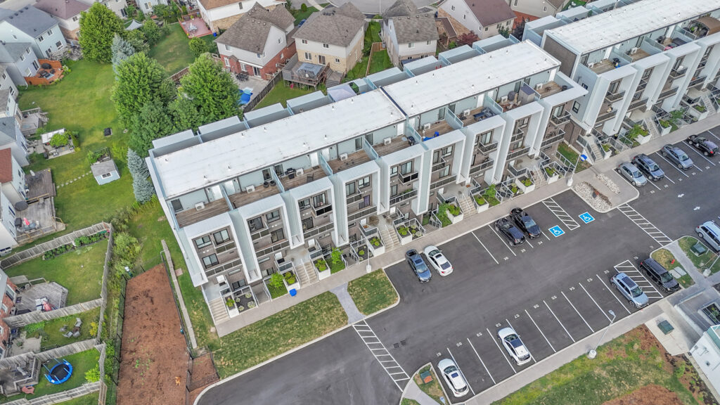 Aerial view of a residential complex featuring multiple buildings and parking lots.
