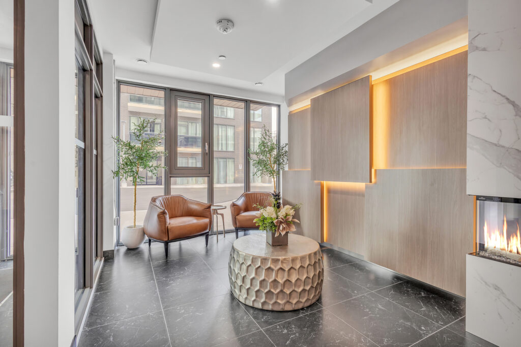 Modern apartment interior featuring a cozy fireplace and elegant marble floors.