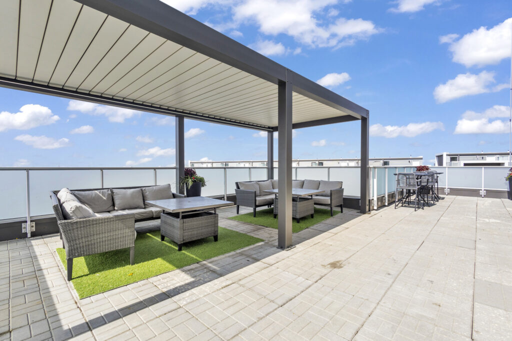 A cozy patio featuring outdoor furniture and a roof for shade.