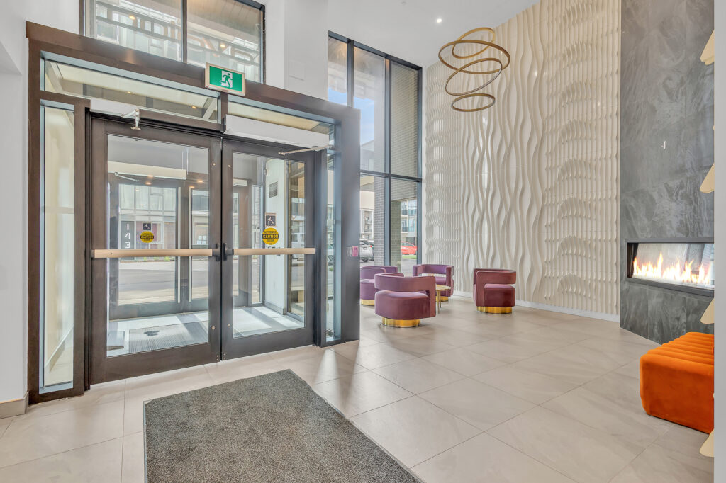 Modern condo entrance featuring a stylish fireplace and contemporary decor.
