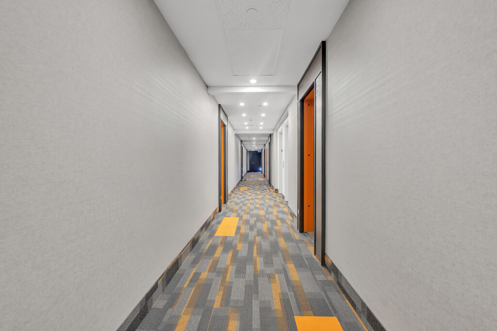 A hallway featuring orange and white patterned flooring.