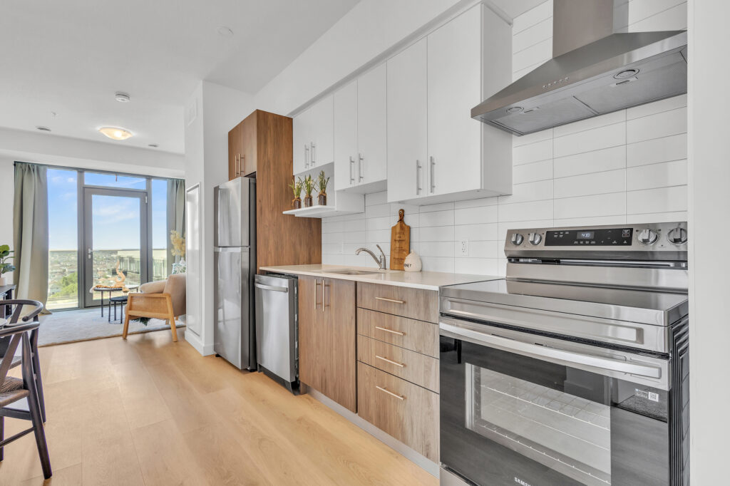 A kitchen featuring a stove, oven, refrigerator, and a dining table.