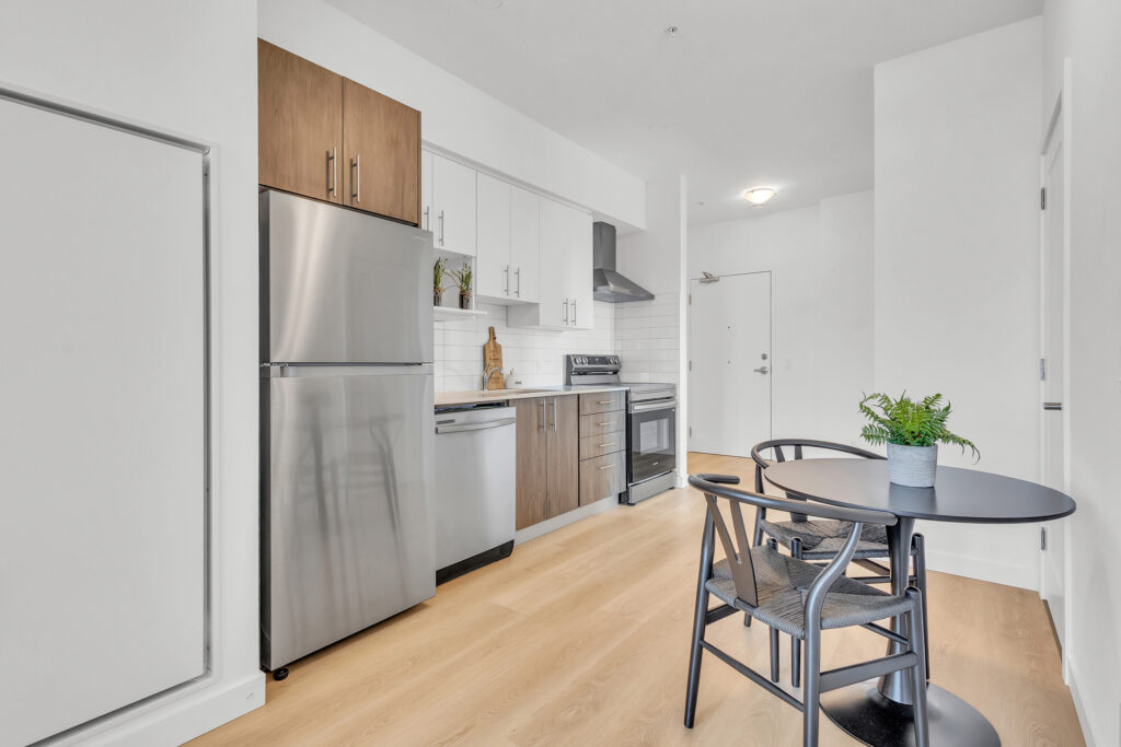A cozy kitchen featuring a wooden table surrounded by four chairs.