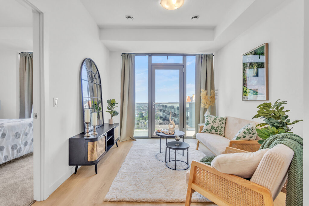 A cozy living room featuring a large window and a comfortable couch.