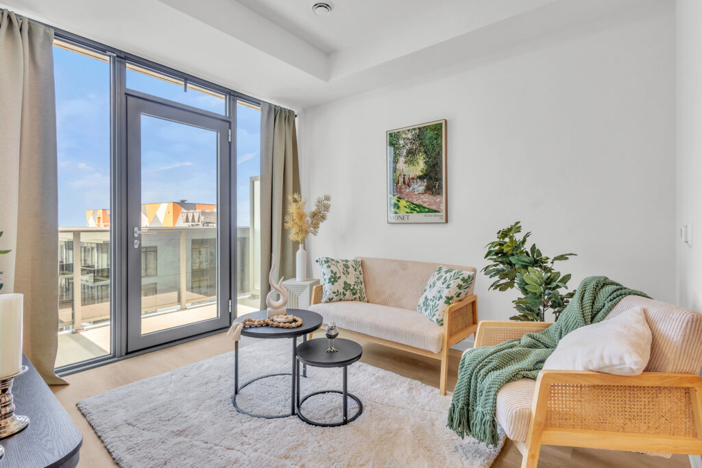 A cozy living room with a large window showcasing a vibrant city skyline.