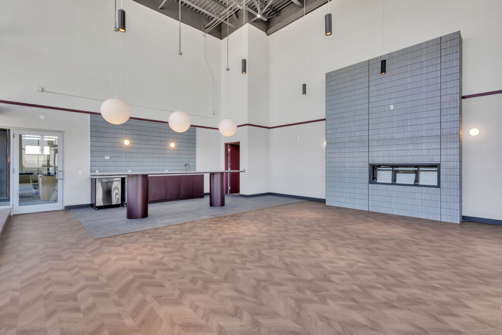 Lobby of an apartment building featuring a cozy fireplace and modern seating arrangements.