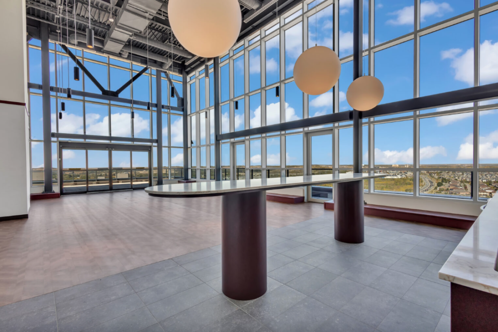 View from the lobby of an office building, showcasing modern architecture and large glass windows.